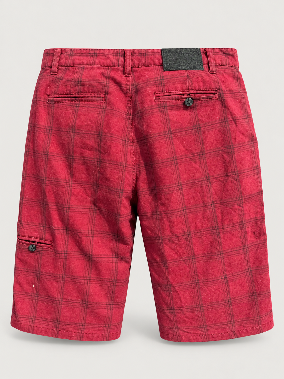 AI-edited studio view of red plaid skate shorts