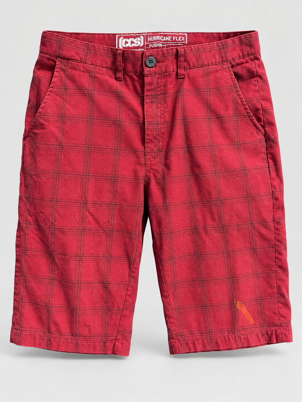 AI-edited studio view of red plaid skate shorts